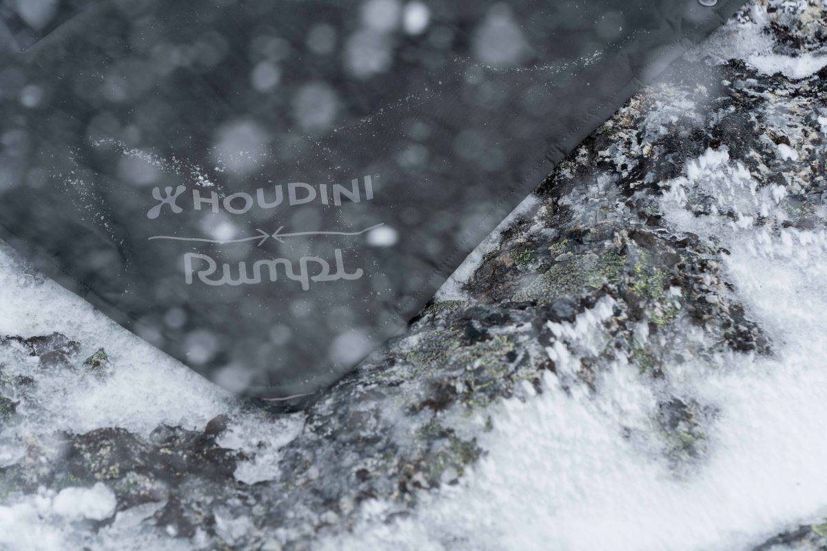 A Rumpl x Houdini Reconnect Puffy Blanket on the snow
