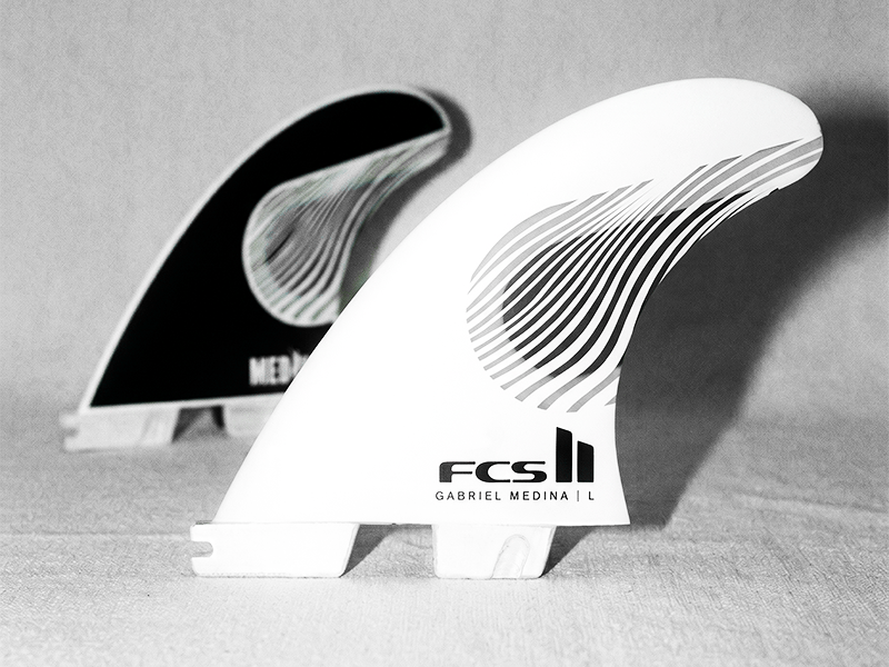 Two surfboard fins in black and white colors.