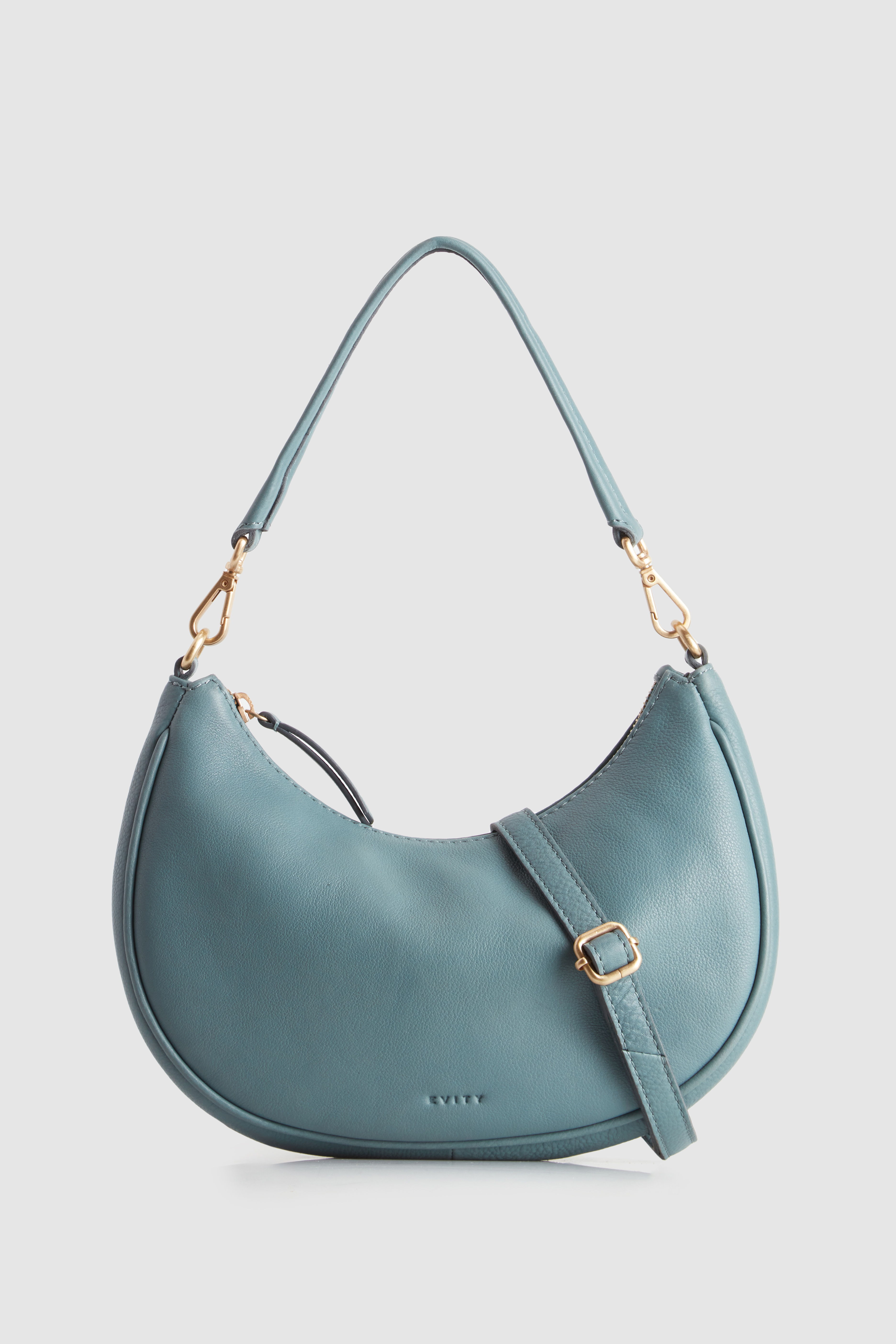 A teal leather handbag with a curved shape and gold hardware.