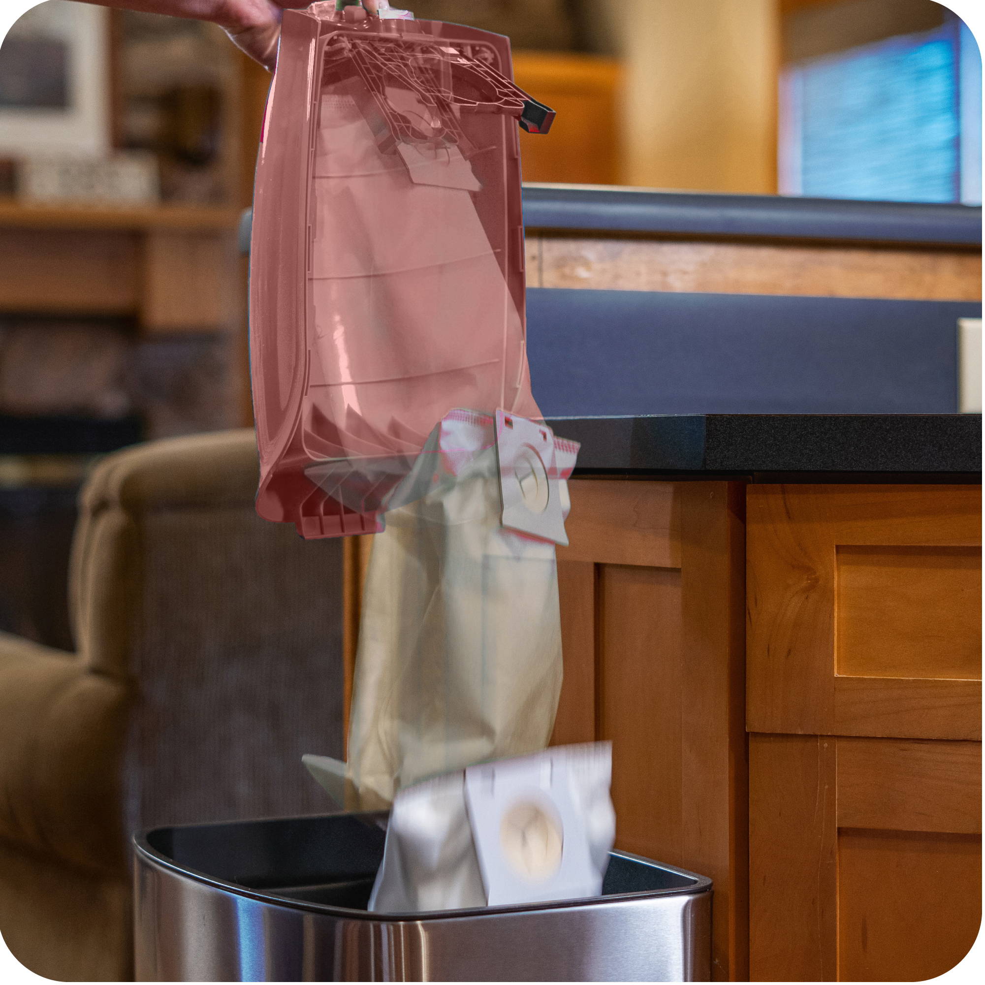 Woman using the No Touch™ Bag technology to throw away a vacuum bag