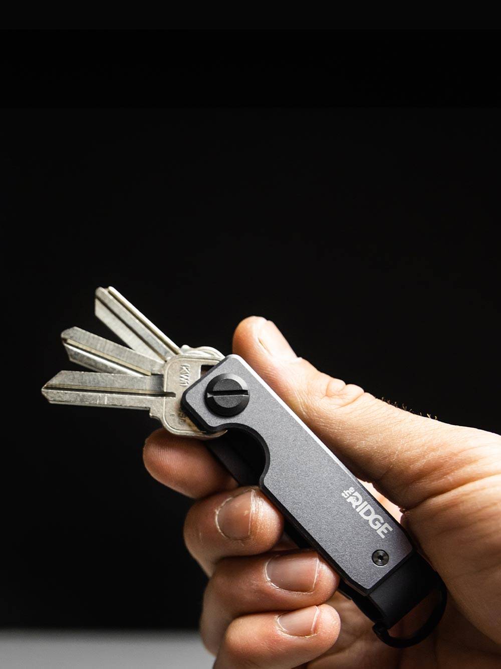 holding a Ridge Gunmetal keycase