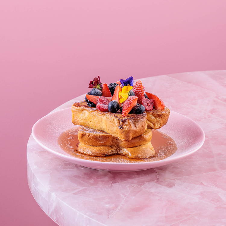 Maple syrup french toast on pink plate