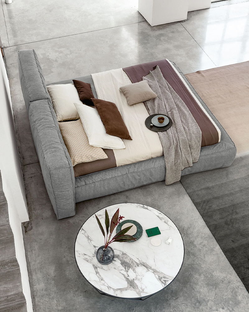 Modern Bonaldo bedroom with a cozy Fluff bed and a round coffee table.