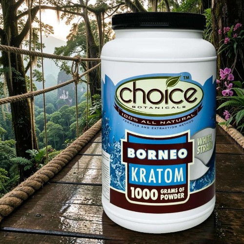 Container of Borneo Kratom powder on a wooden surface in a tropical setting.