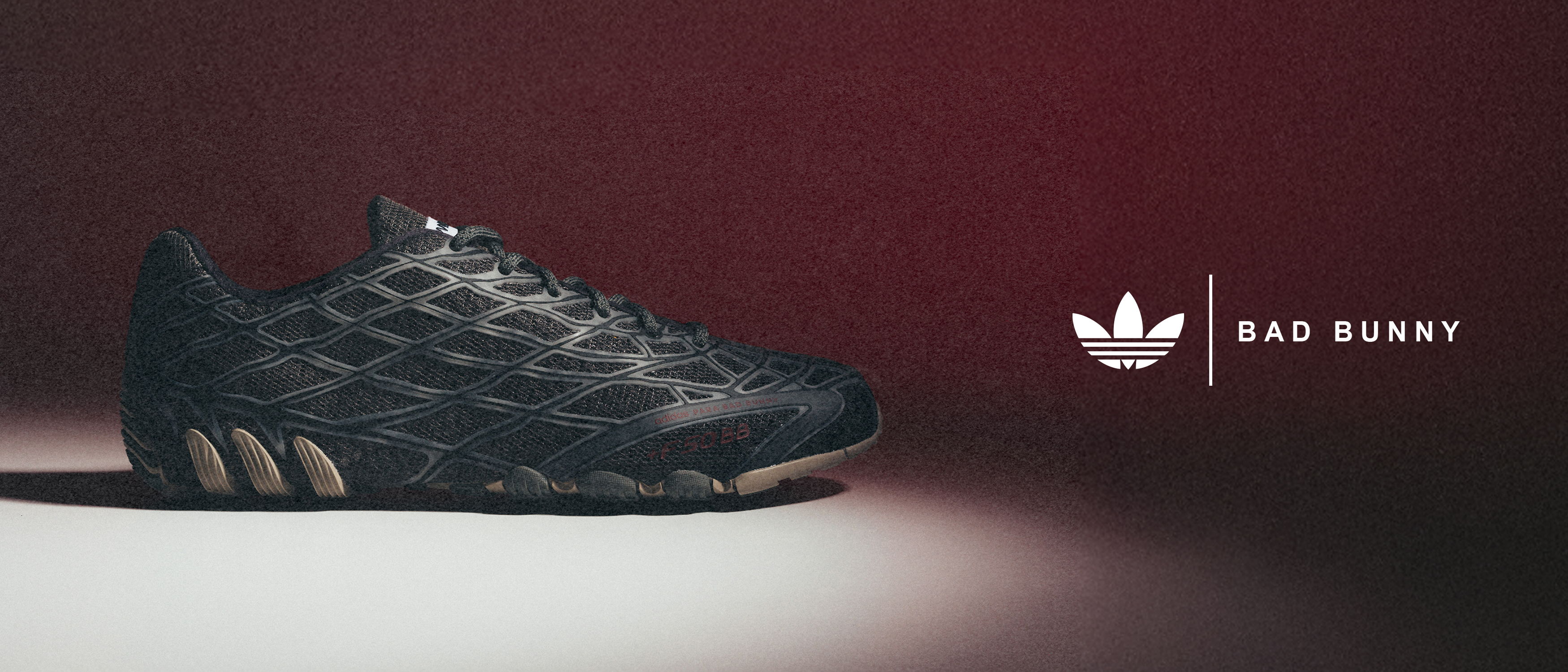 Black athletic shoe with Adidas logo and branding.