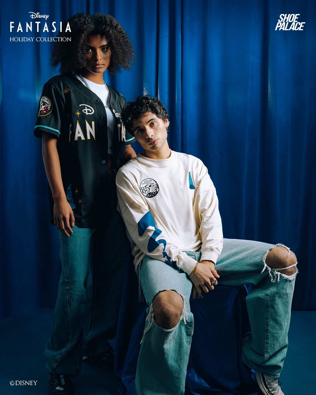 Two models in casual clothing against a blue backdrop.