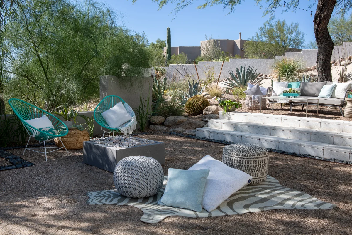 Desert-inspired Arizona backyard with shaded lounge spaces, native plants, gravel landscaping, and outdoor seating designed for cooling comfort and casual gathering.