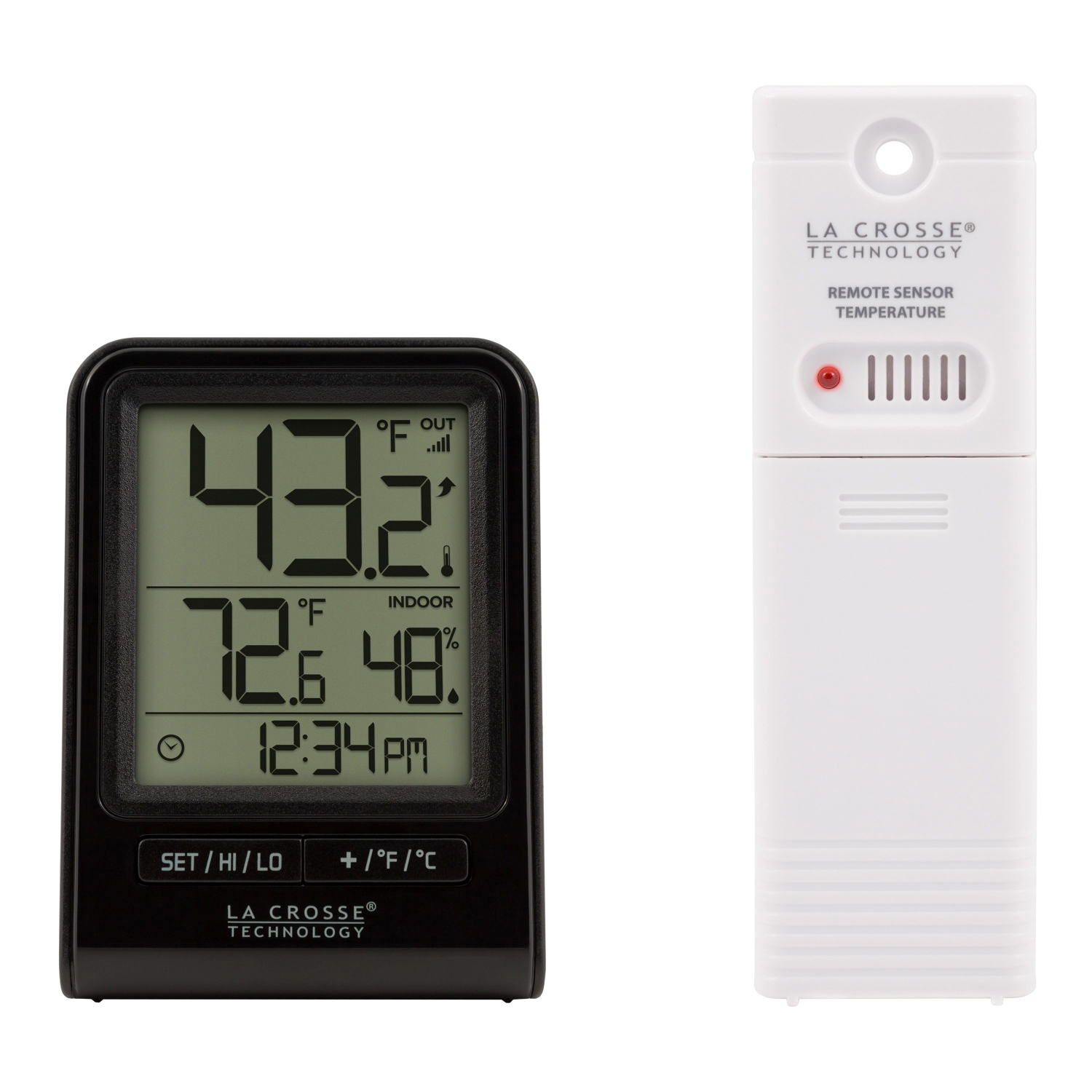 Digital thermometer next to a decorative glass container and strap.