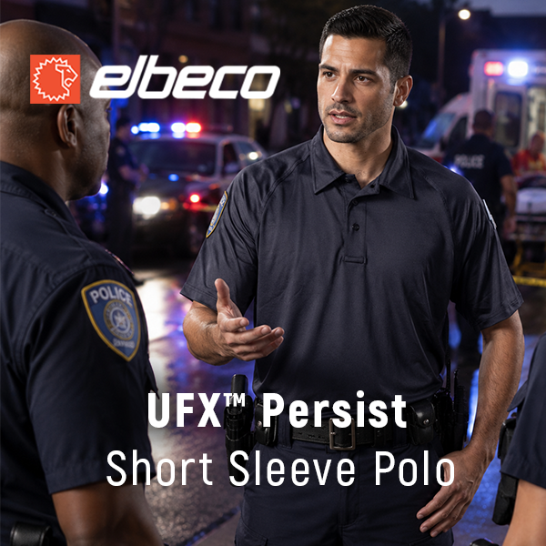 Two police officers discussing while wearing Elbeco uniforms at night.