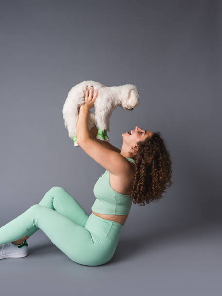 Yoga girl with white dog in shoes