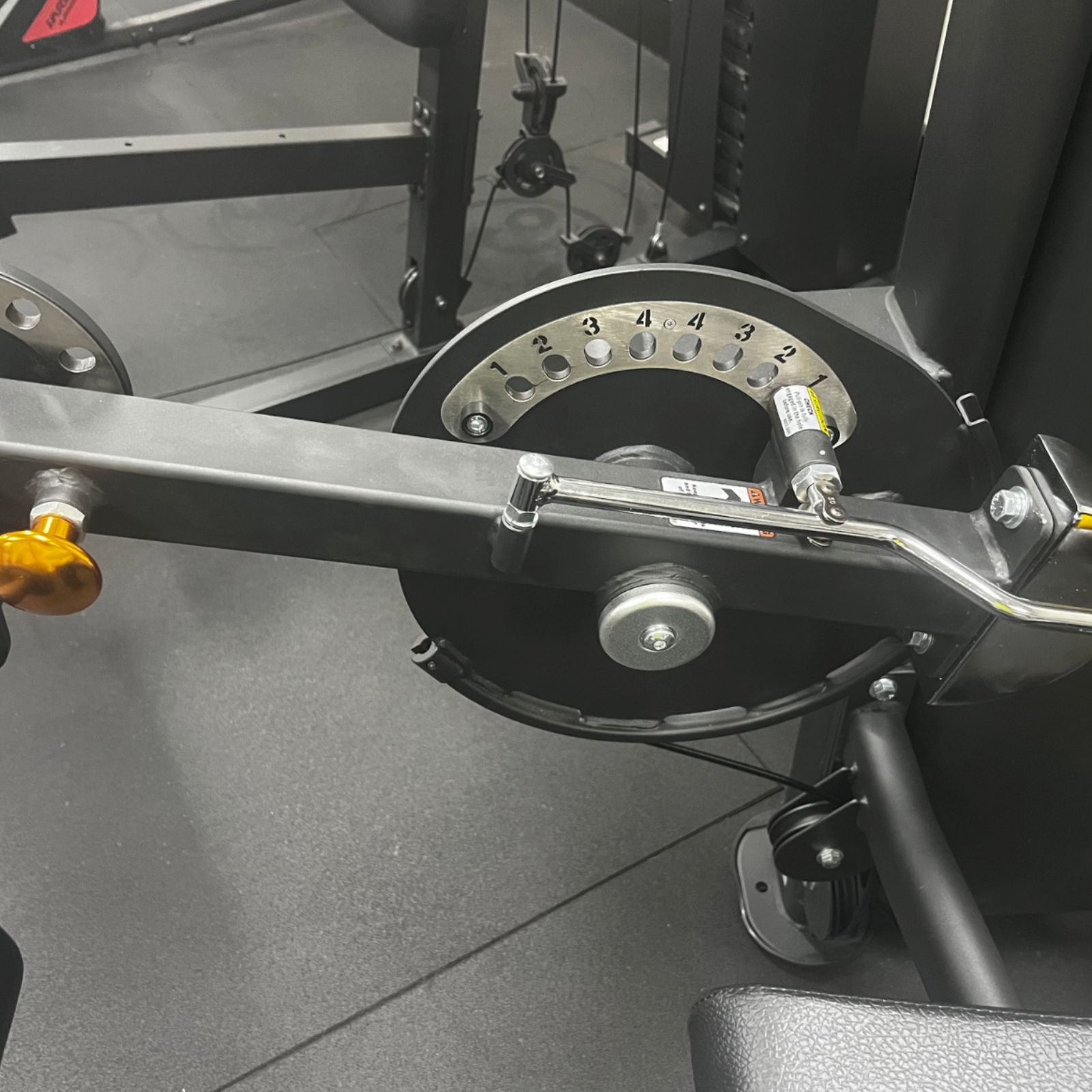 Close-up of a weight machine's mechanism and settings.