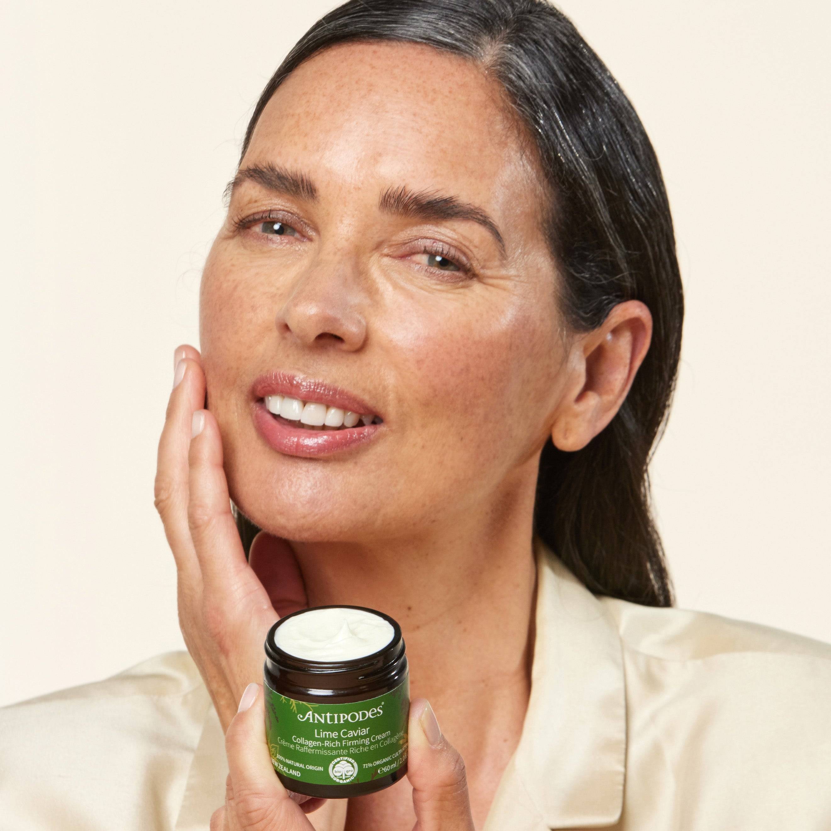 Mature woman holding Lime Caviar Collagen-Rich Firming Cream.