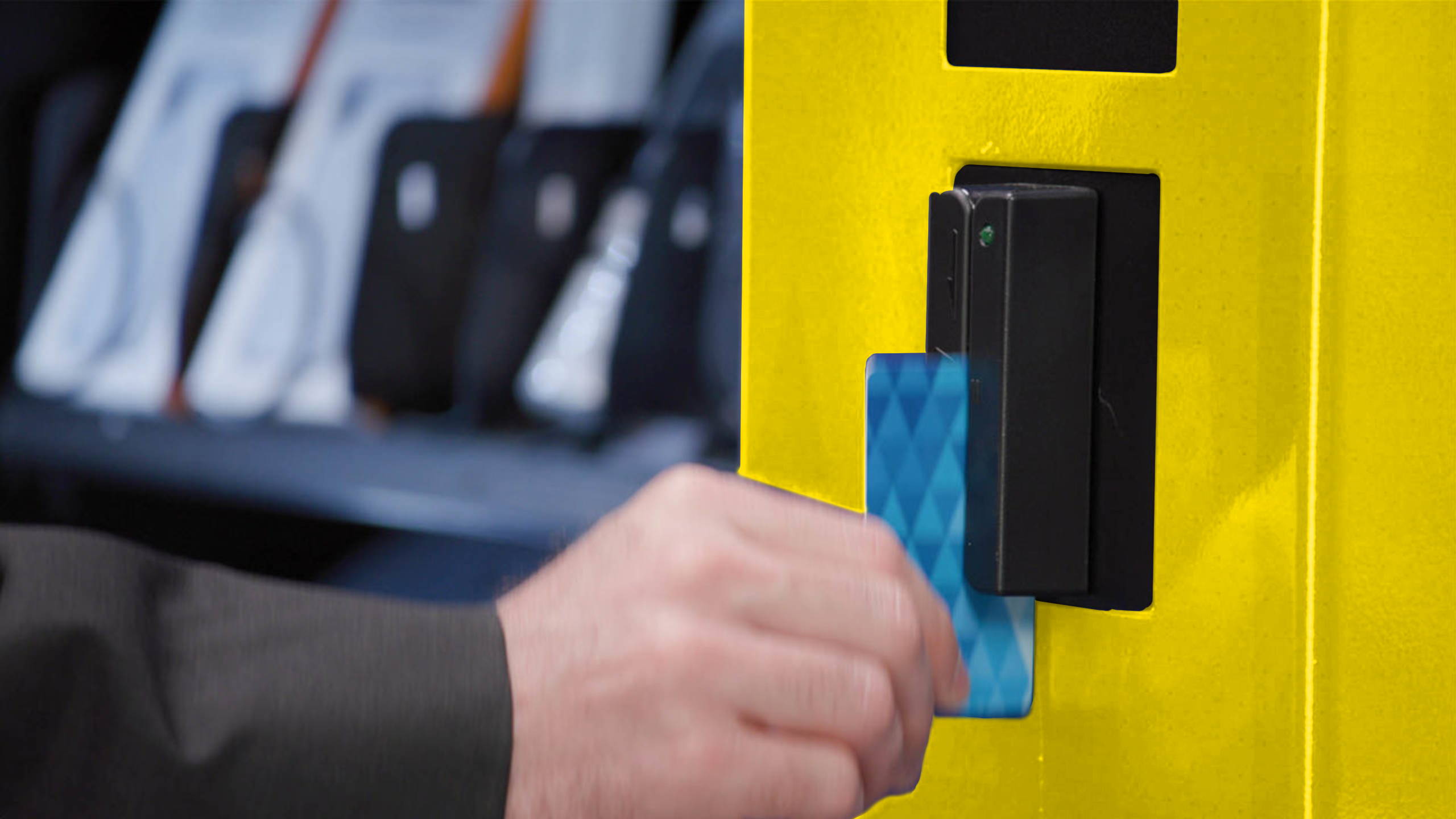 Man using magnetic strip on ppe vending machine.