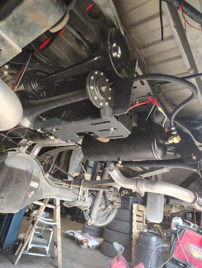 Three black train horns air tank custom brackets rear differential exhaust garage welding machine Christie's 2019 Tundra 2-Gallon Stealth install gallery photo 3