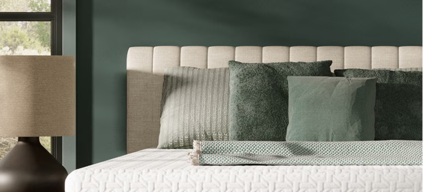 Mattress display featuring Nectar mattress branding and layered bedding.