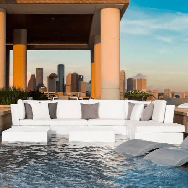 White in-pool sectional with white and grey pillows.