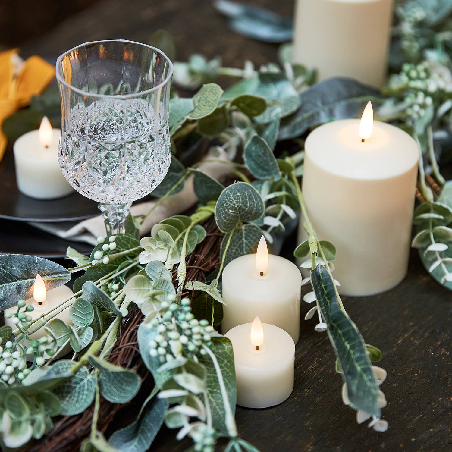 Eucalyptus garland styled with TruGlow candles as part of a centrepiece 