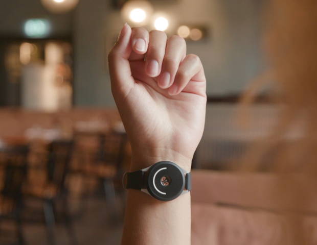 woman wearing doppel on her wrist in a restaurant