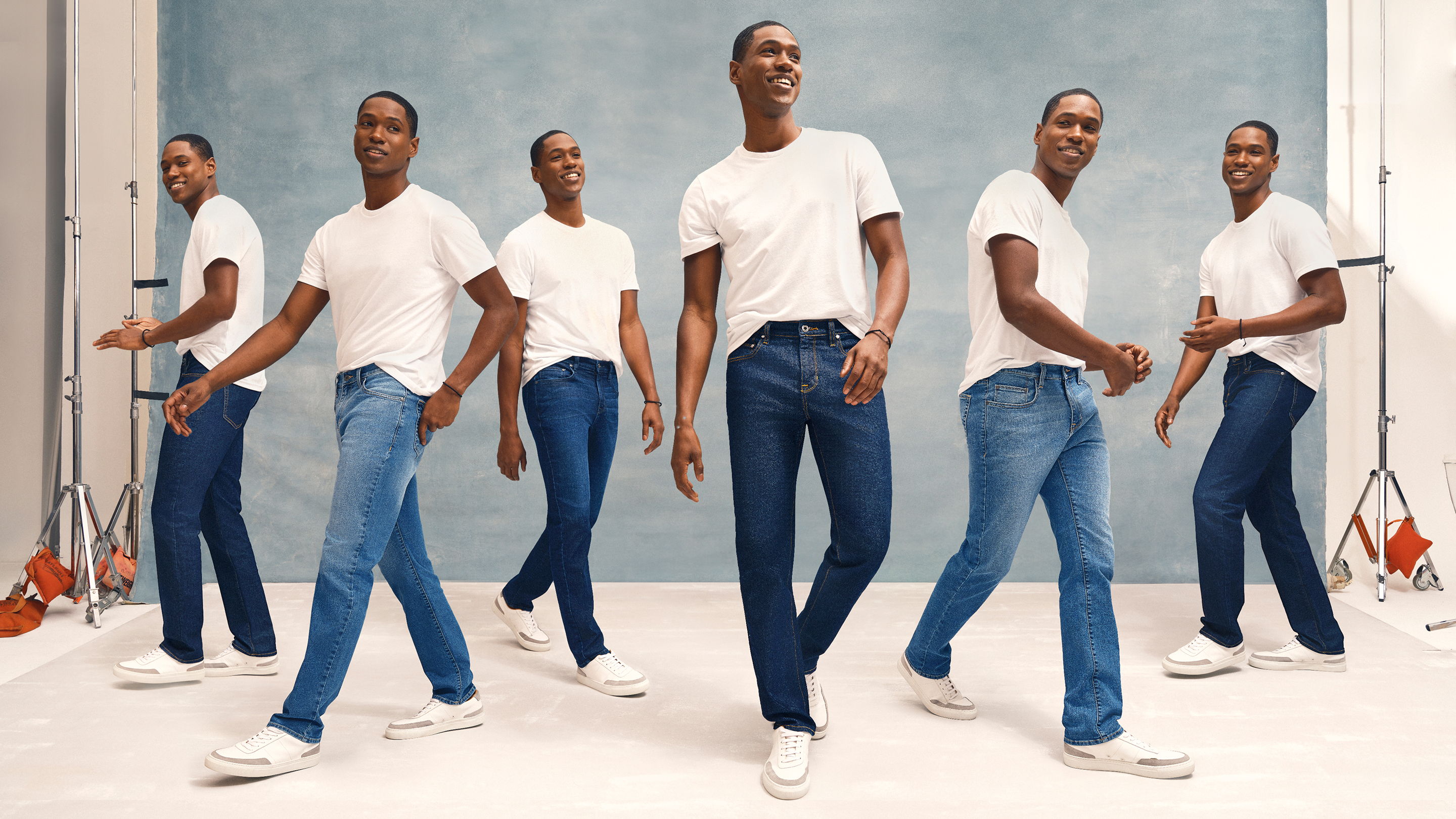 A man in a white shirt and jeans poses in multiple positions.