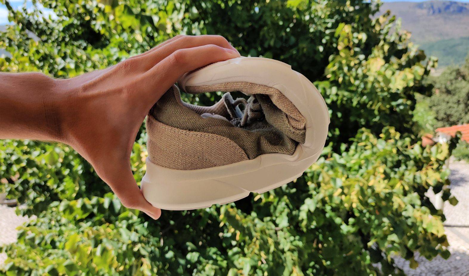 Strong and flexible hemp: hemp shoe being folded to show its flexibility