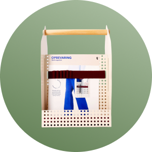 A storage box with magazines and ribbons in a circular background.