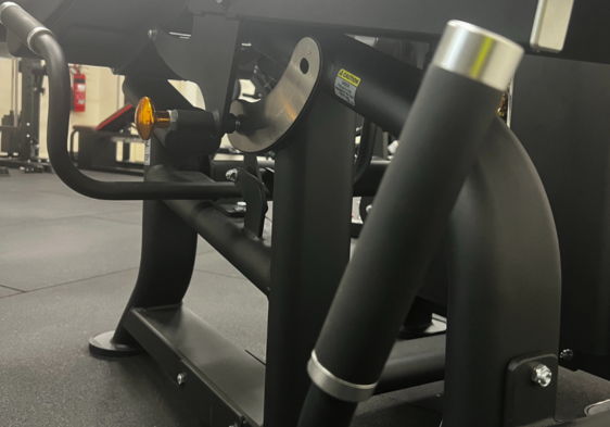 Close-up of gym equipment showing various components and handles.