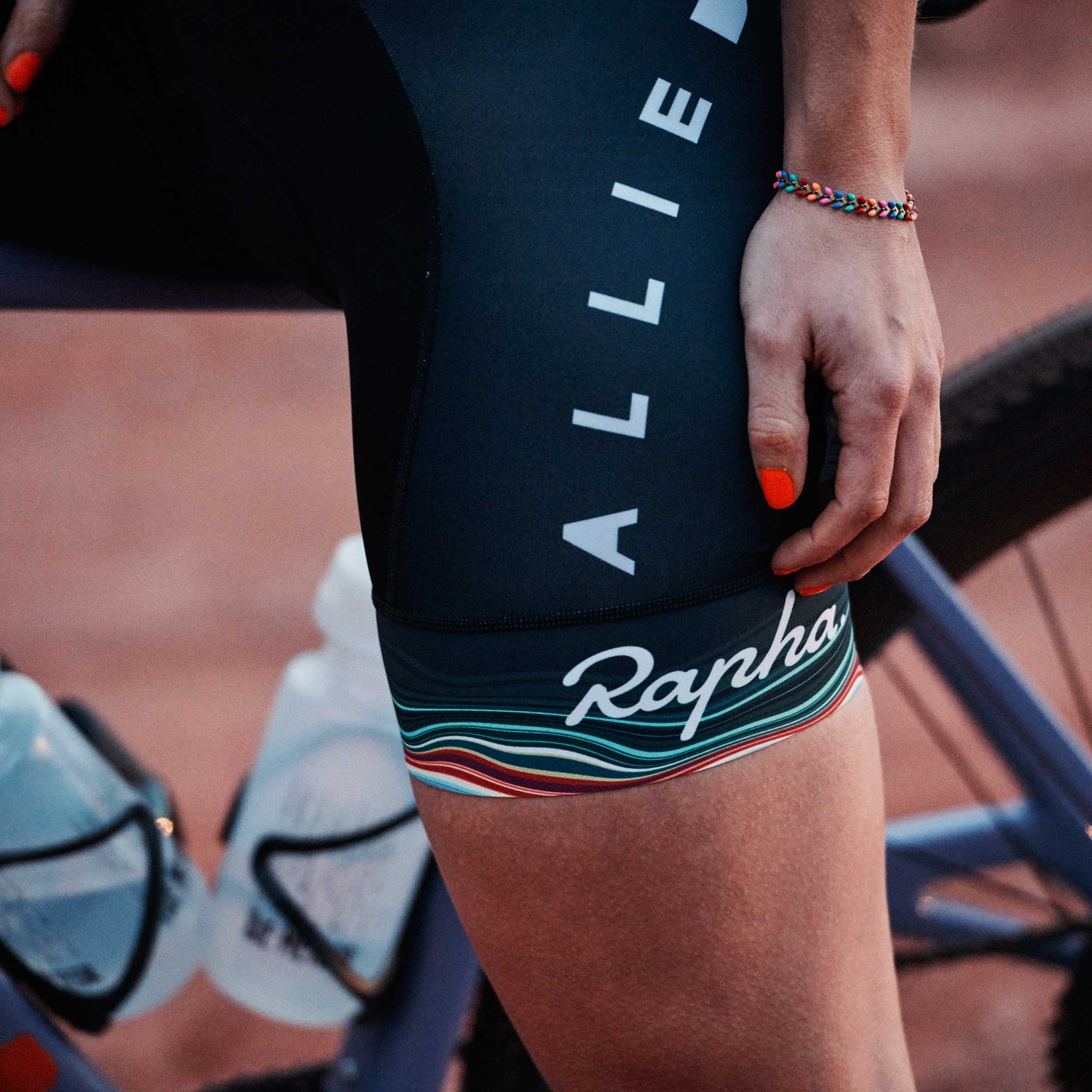 Katie Kantzes sitting on a bike wearing Allied Rapha shorts