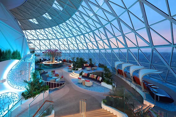 Modern architectural interior with large glass windows and stylish seating areas.