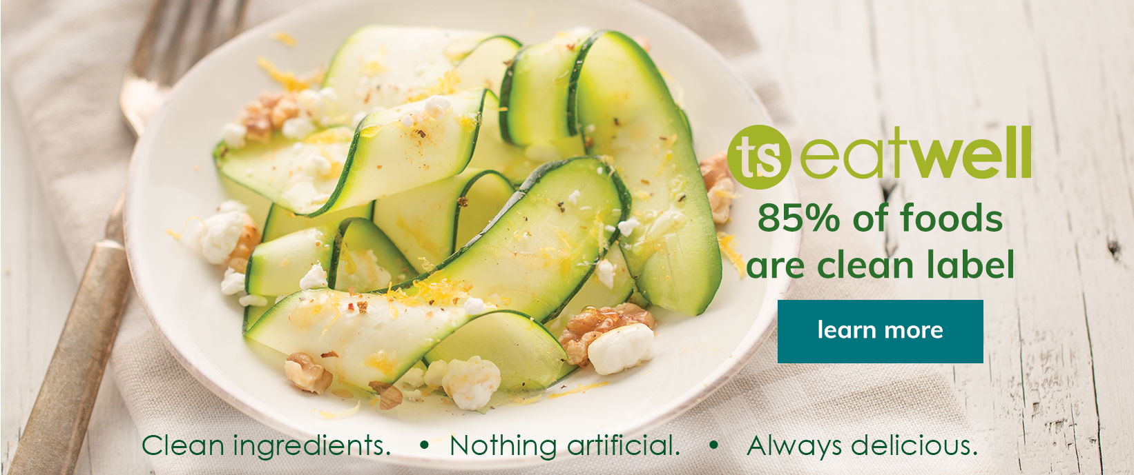ts eatwell banner featuring a a zucchini dish with a learn more button
