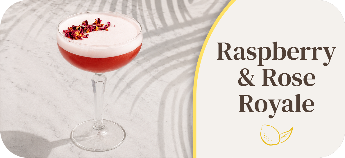 Cocktail glass filled with raspberry and rose drink, garnished with rose petals.