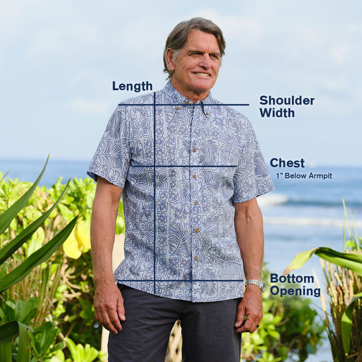 Man in a floral shirt with measurement labels for clothing dimensions.