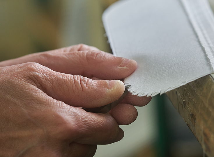 A hand holding a piece of paper or cardstock.