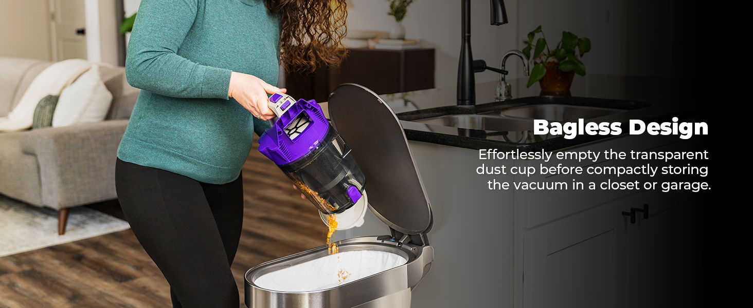 Person using a bagless vacuum cleaner to empty its contents into a trash can.