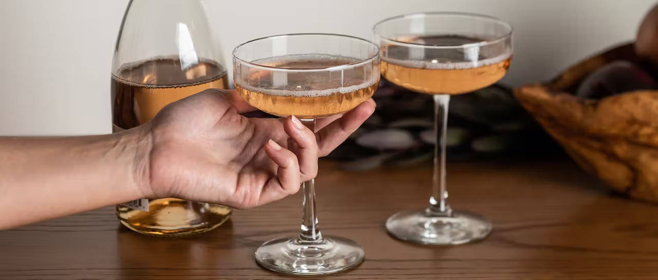 hand holding a glass of sparking wine