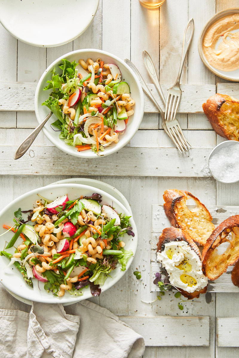 Two bowls of vegetable whole-wheat pasta salad