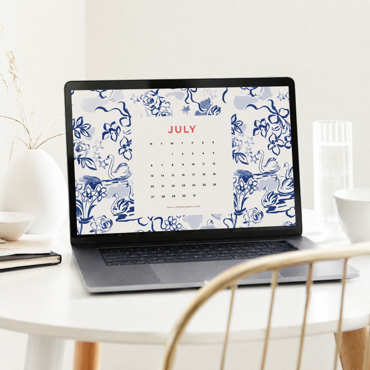 july 2026 digital wallpaper showing swans on a laptop, white table, chair, vase, books, glass, bowl