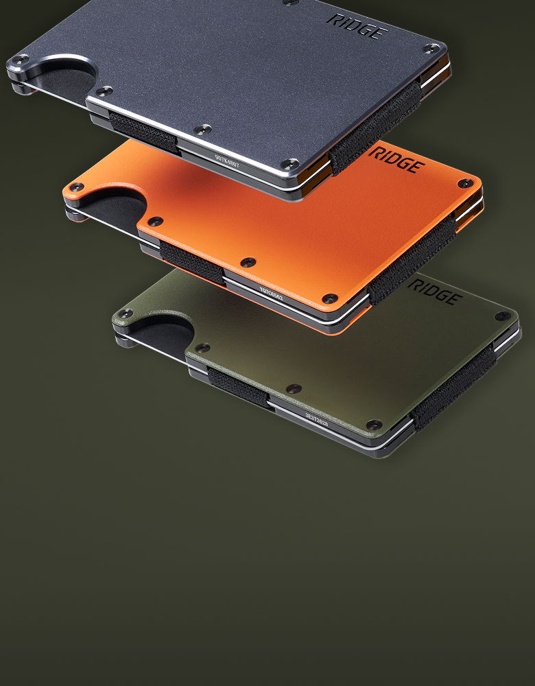 Three modern wallets in black, orange, and transparent layers.