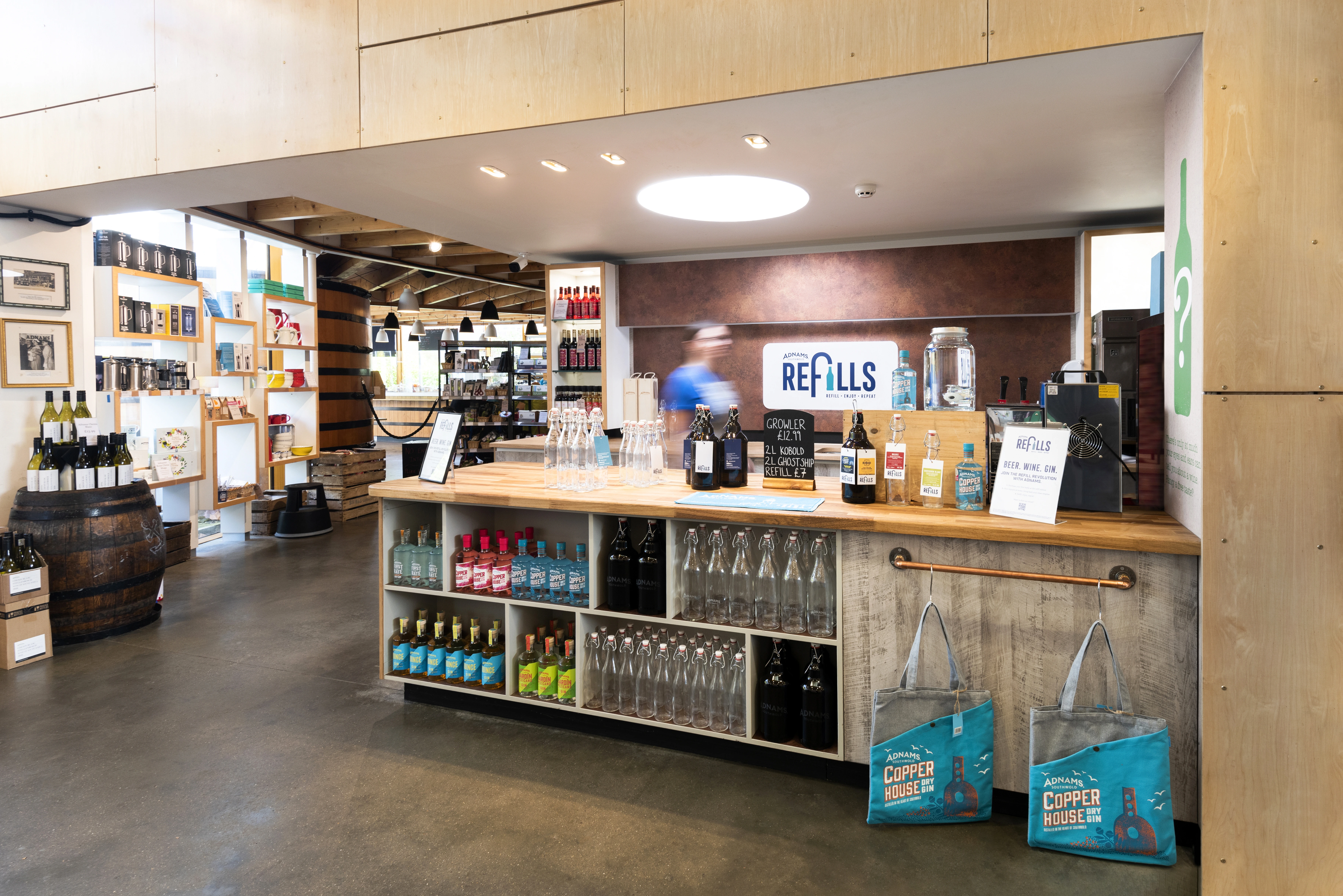 A modern retail space with a counter and shelves filled with products.