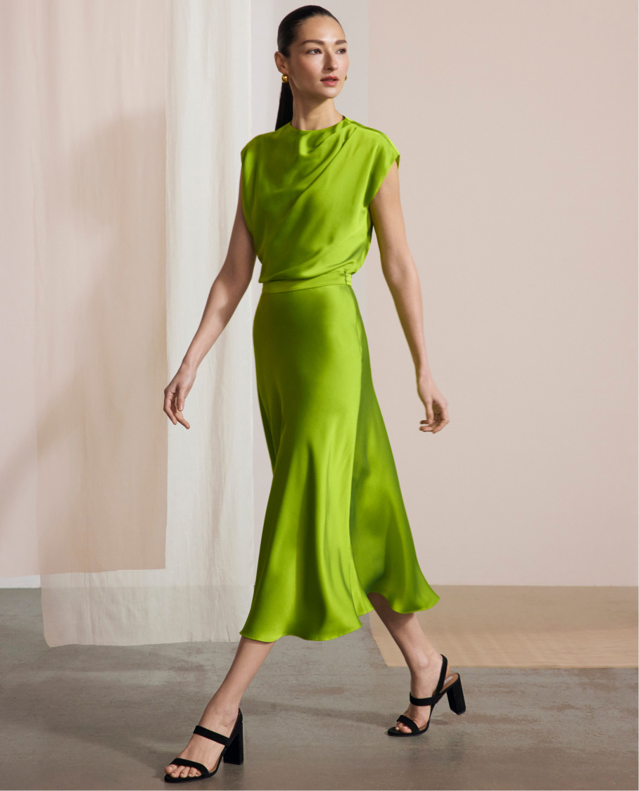 Model wearing vivid lime green Skye top and Kelmore skirt