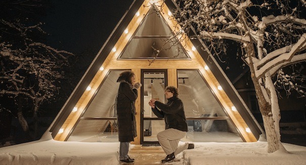 romantic new years eve proposal outside of a warm cozy cabin