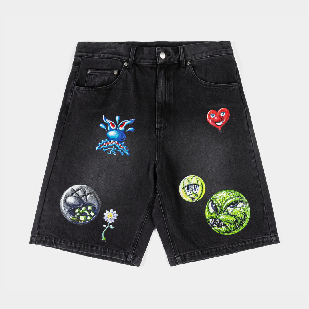 Black denim shorts with colorful patches and designs.