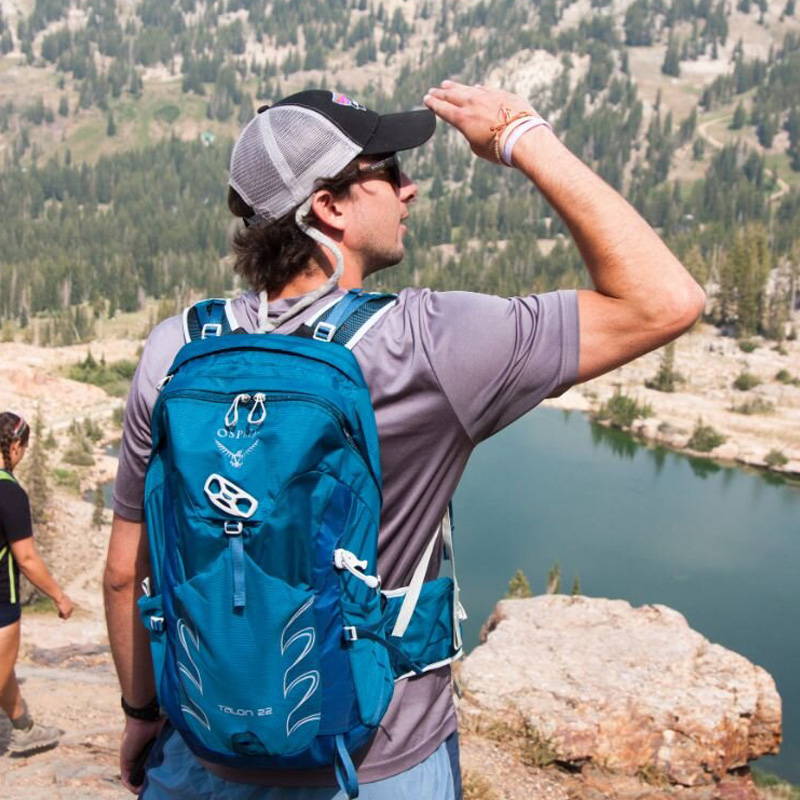 Man Hiking while wearing Osprey Talon 22 day-hiking backpack