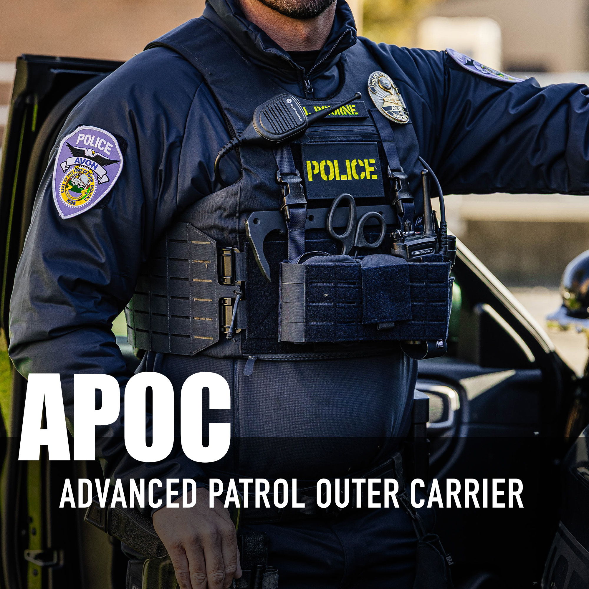 Police officer wearing an advanced patrol outer carrier vest.