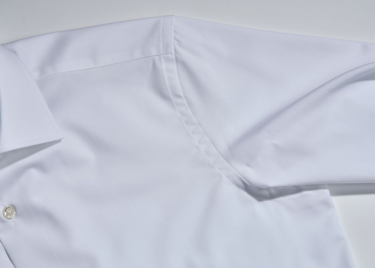 Close-up of a white shirt sleeve and collar.