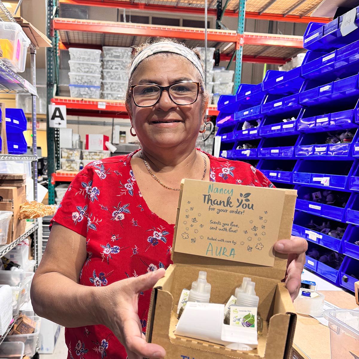 Image of employee holding box