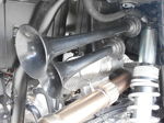 Close-up dual black air horn trumpets white coil spring exhaust heat shield braided flex pipe KJ Motorsports Polaris RZR train horn kit gallery photo 5