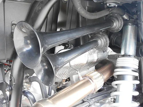 Close-up dual black air horn trumpets white coil spring exhaust heat shield braided flex pipe KJ Motorsports Polaris RZR train horn kit gallery photo 5