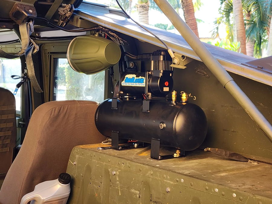 Cabin-mounted HornBlasters air tank compressor olive drab interior palm trees window Jack L. 2001 Humvee Outlaw 228H onboard air gallery photo 3