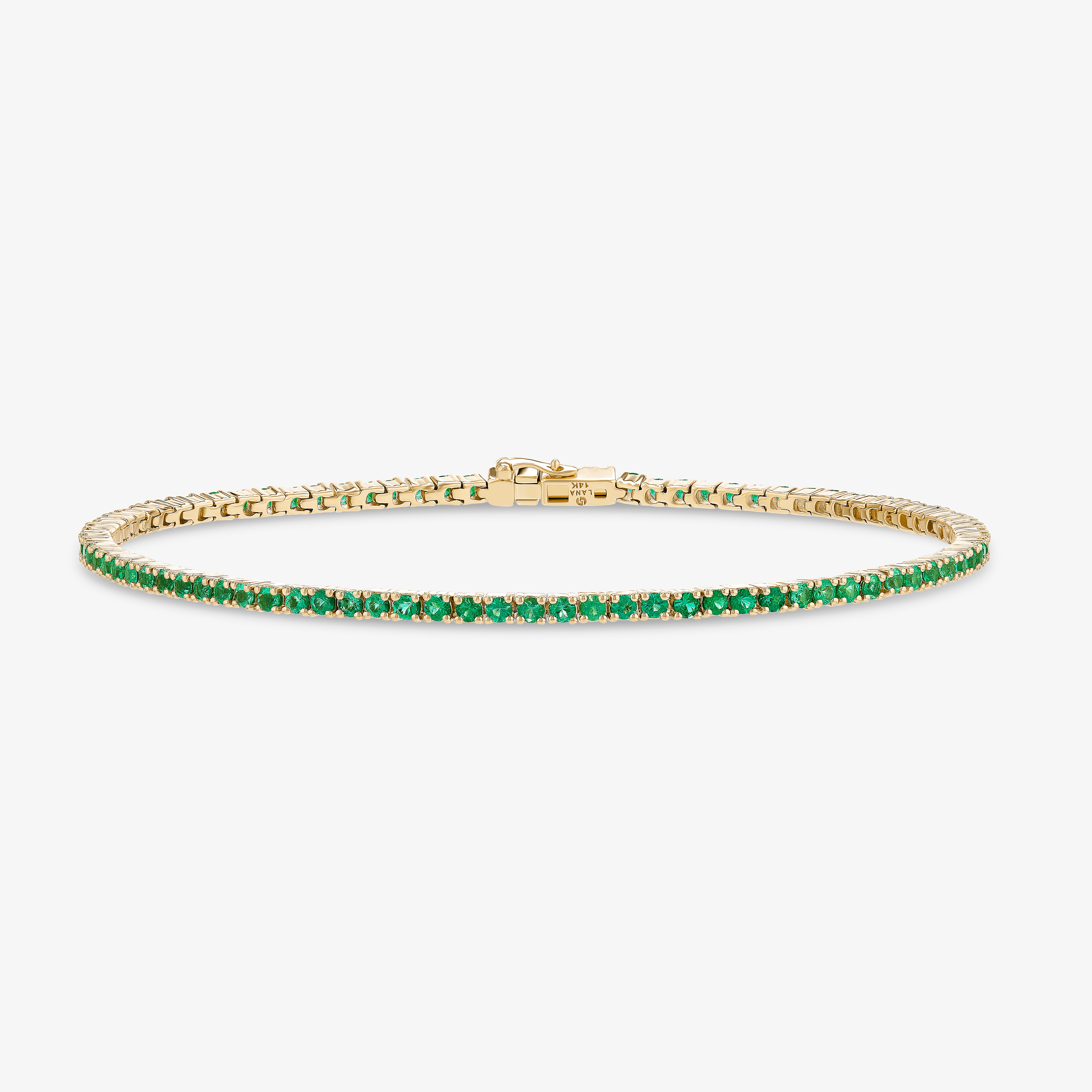 Elegant gold bracelet adorned with green gemstones.