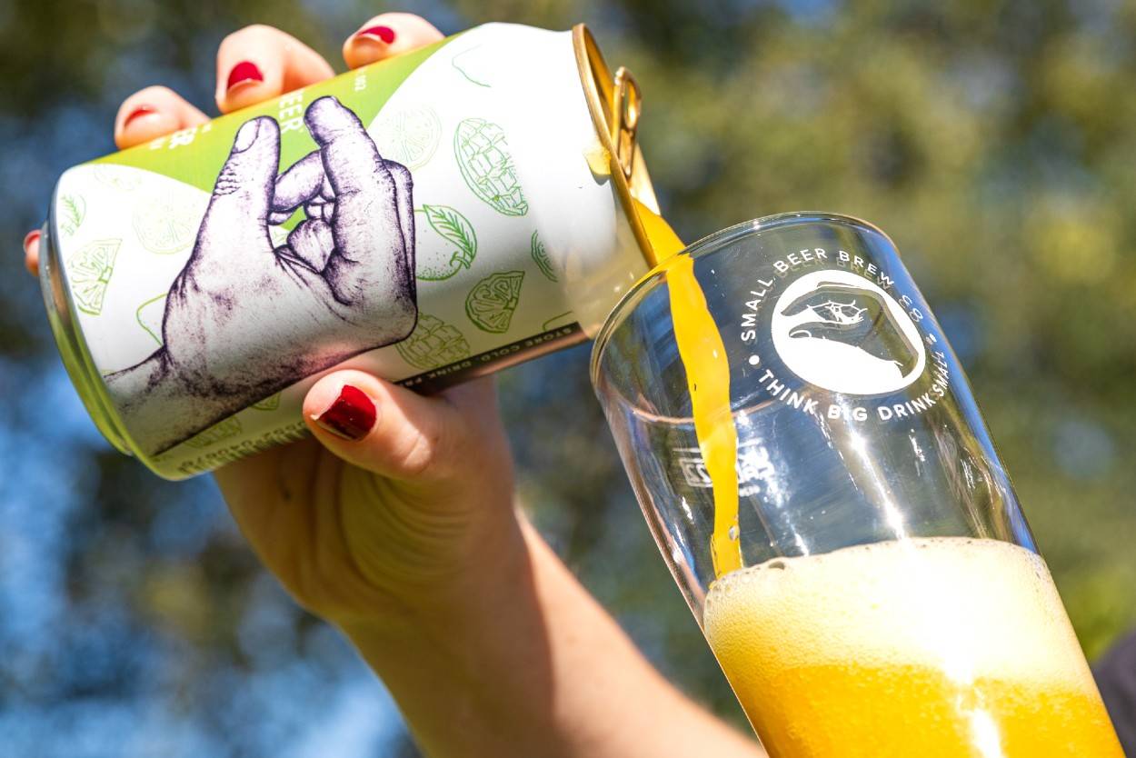 Small Beer Radler pouring into a glass on sunny day